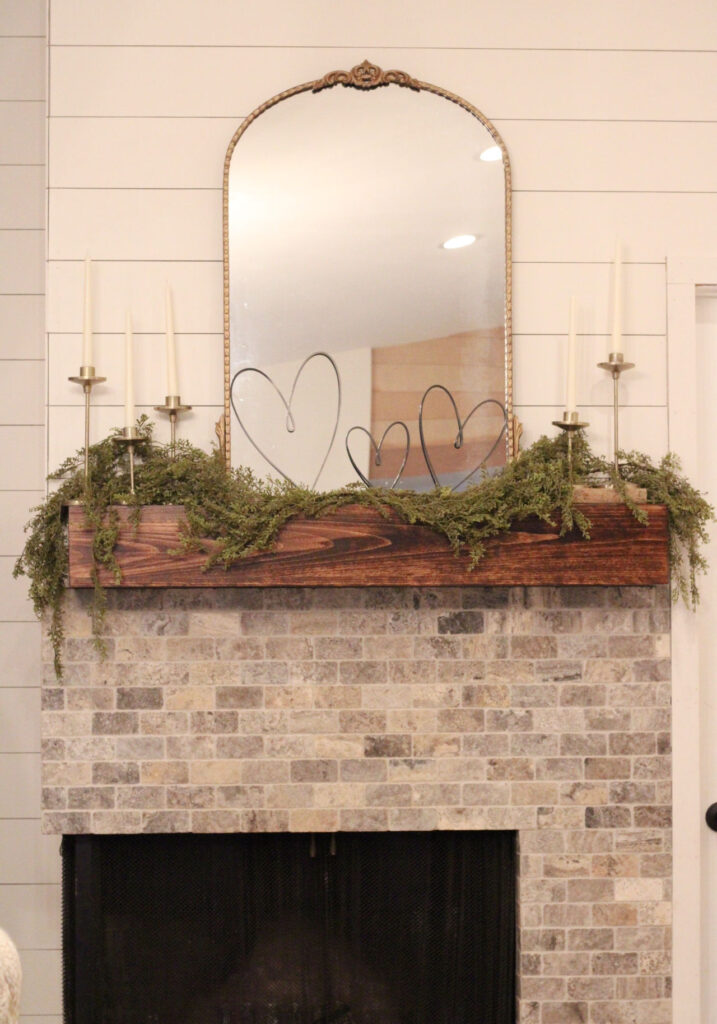 fireplace manel with gold mirror and black hearts and candles