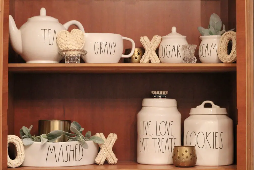 wood hutch with ivory rae dunn canisters and xo and heart ivory fillers and gold accents