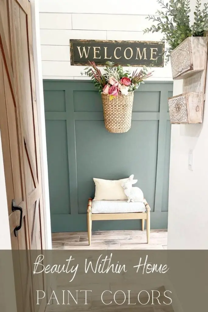 A green painted board and batten wall with white shiplap above it, a basket with pink flowers hanging on the wall and a wood bench underneath. The words "Beauty Within Home Paint Colors" is written at the bottom. 