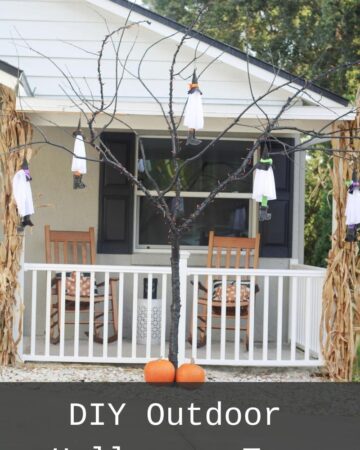 A close up of a black tree with no leaves and white ghosts hanging off of it and its in front of a grey and White House with the words DIY Outdoor Halloween Tree written on the bottom