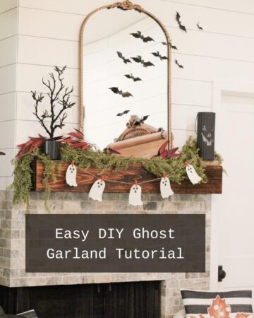 A Halloween decorated fireplace wood mantel with a white paper book ghost garland on a burlap string hanging with orange clothes pins, with a black jack o lantern and a black tree on the mantel. With the words in a black background and white text that says: "Easy DIY Ghost Garland Tutorial"