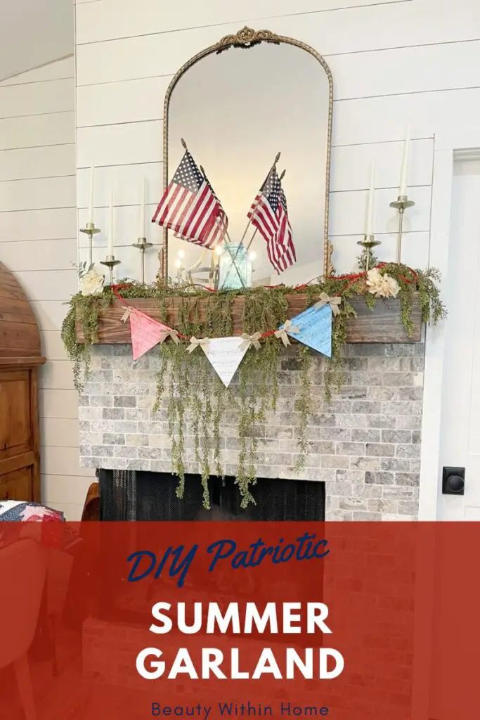 A wood mantel and brick fireplace with a red, white, and blue garland with red string across it on top of greenery garland and a gold mirror. The words at the bottom say "DIY Patriotic Summer Garland. Beauty Within Home"