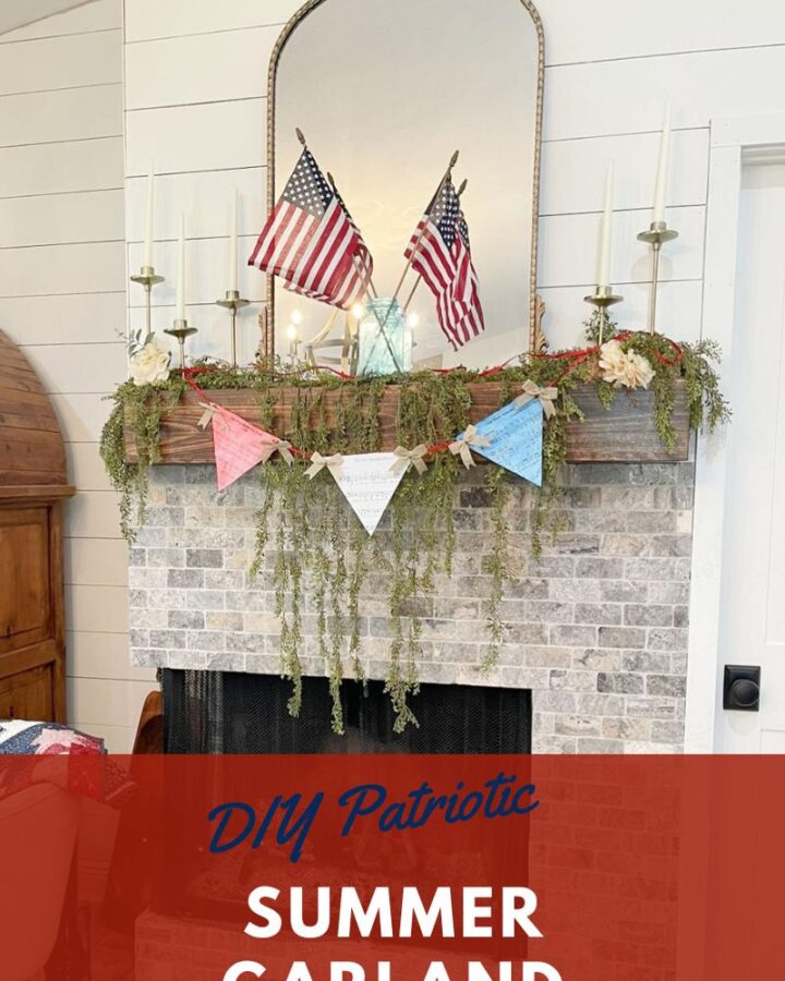 A wood mantel and brick fireplace with a red, white, and blue garland with red string across it on top of greenery garland and a gold mirror. The words at the bottom say "DIY Patriotic Summer Garland. Beauty Within Home"