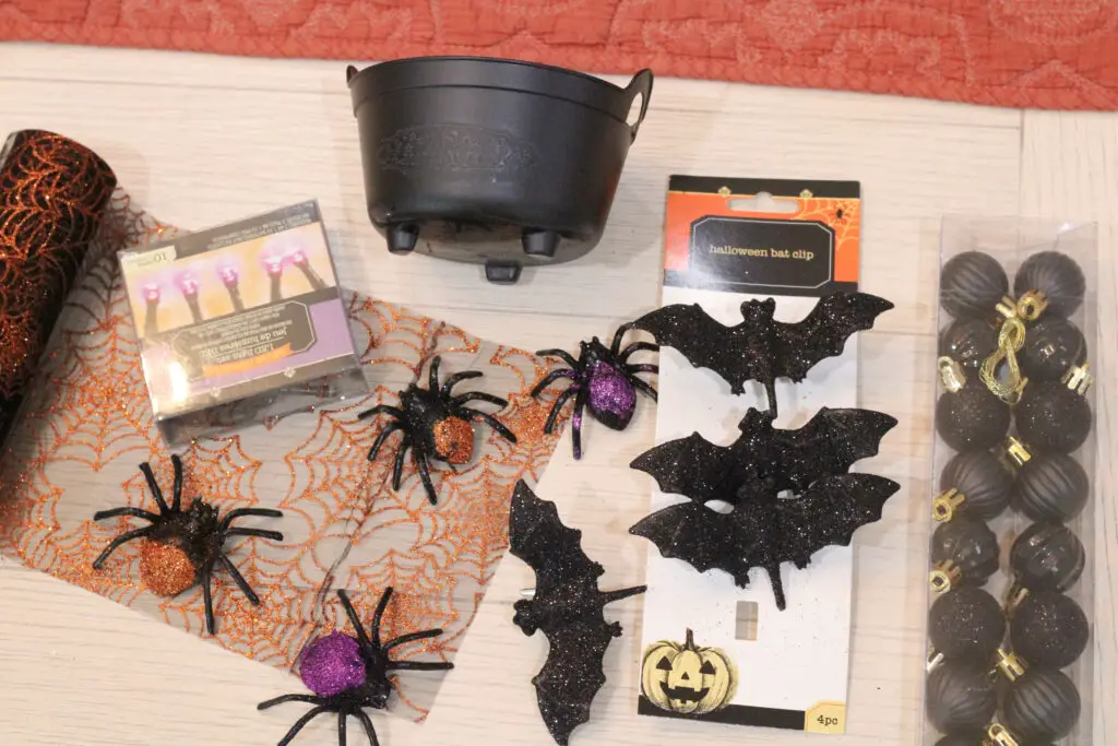 close up of black and orange spiders, black and purple spiders, black glittery bats, black small ornaments, orange and black spider web lace