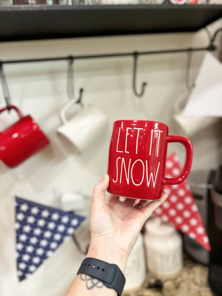 close up of a red mug that says let it snow in white letters